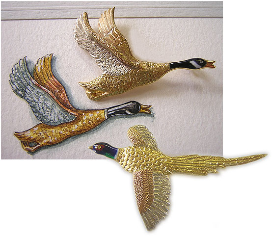 gold and enamel bird brooches